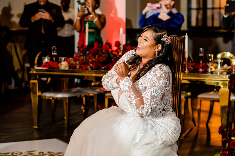 Captured after their wedding at The Cotton Press, this fashionable Black couple poses in the marble inset at the SC Statehouse, with the bride's veil flowing gracefully. A picture of style and luxury.