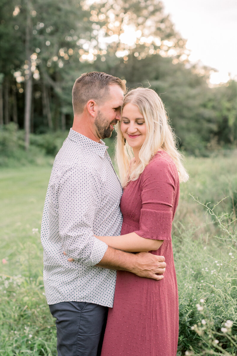 Couple snuggling closely at a family photography session