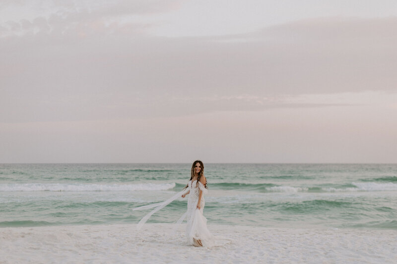 bride stands on beach