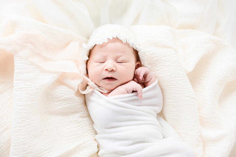 sleeping baby in bonnet