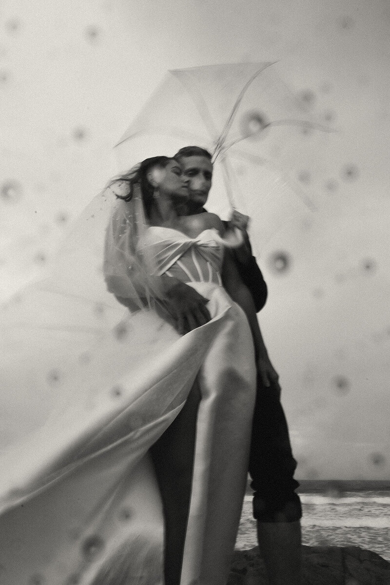 Brisbane photographer capturing a romantic wedding kiss beneath a soft flowing veil.