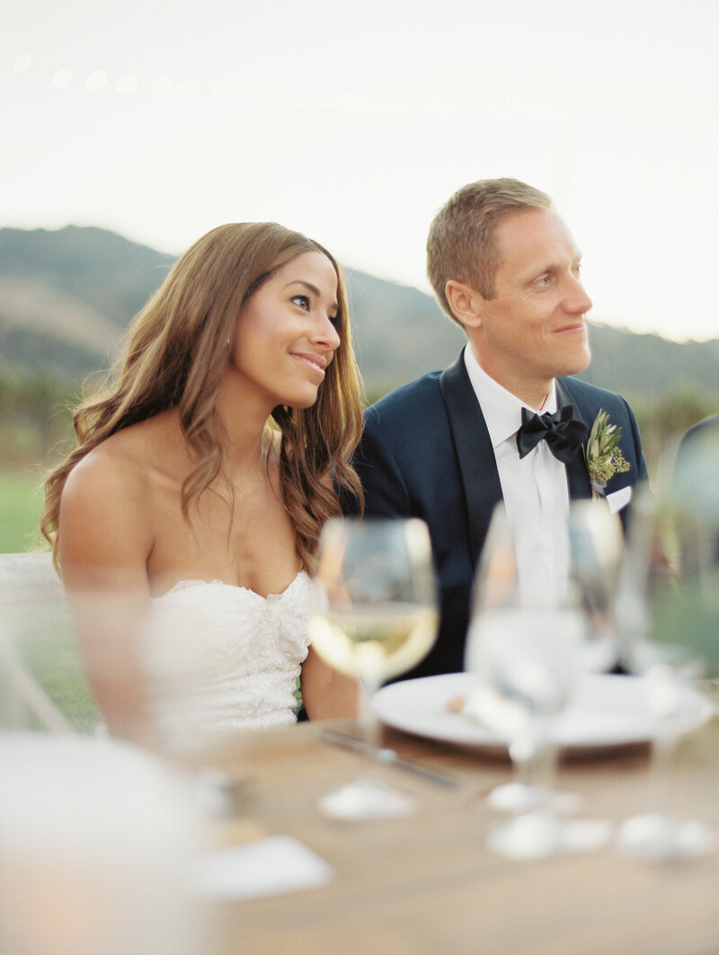 earth tone table setting with olive branch and peach flowers at outdoor reception in santa ynez, ca