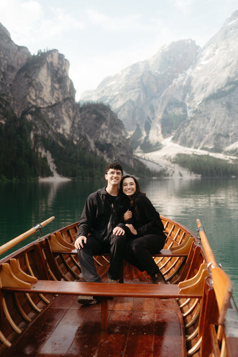 Dolomites Elopement Photographers The Chaffins smiling in a wood boat at Lago di Braies 