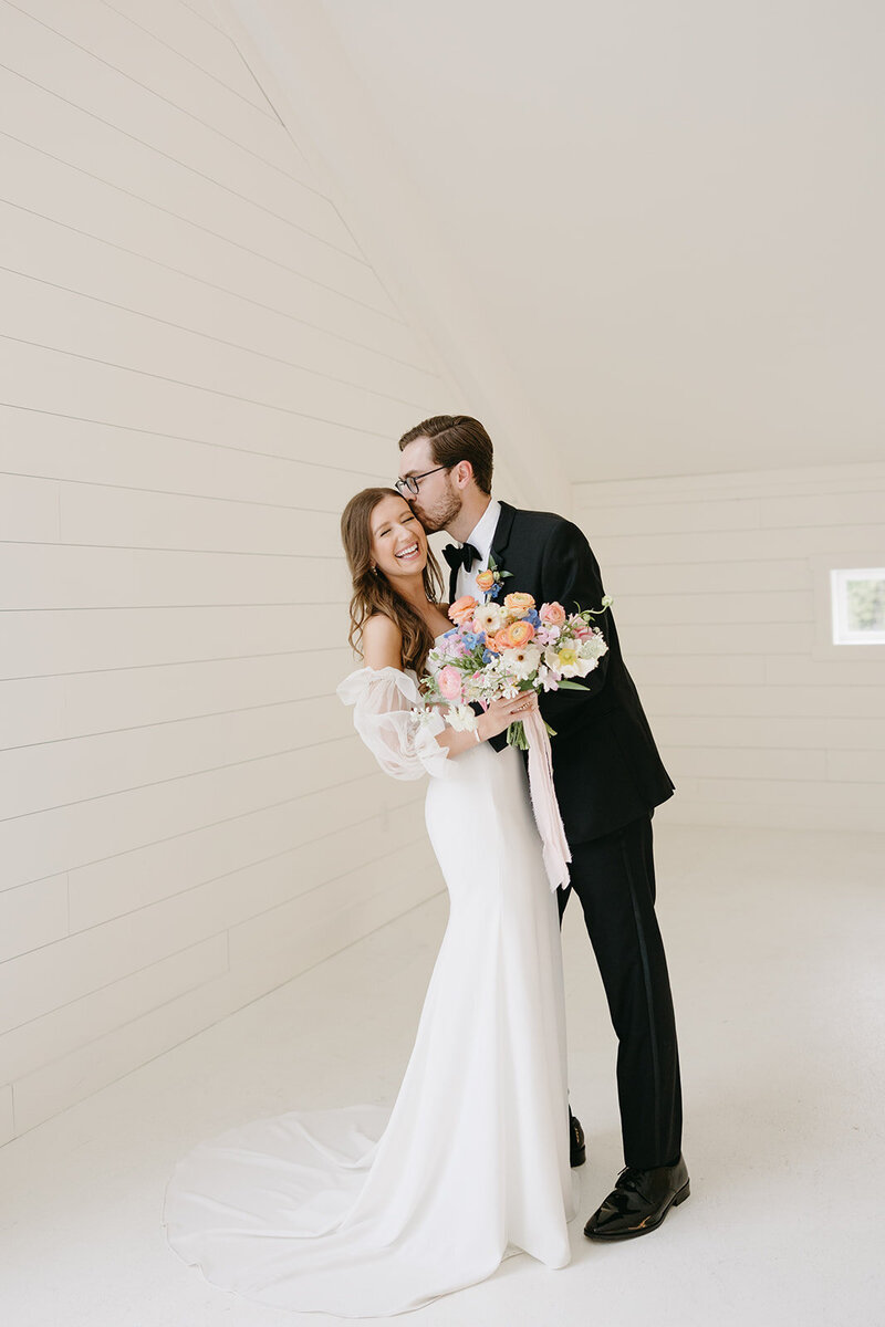 bride and groom in a white paneled room