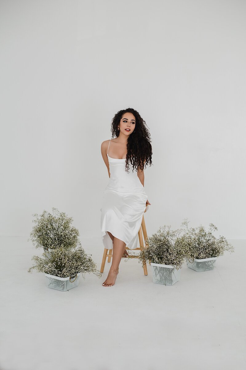 Woman surrounded by flowers in  studio photoshoot in albuquerque.