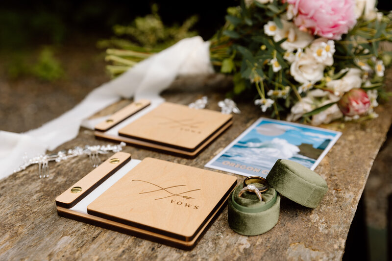 Details like vow books, rings and ring box, a postcard and flowers.