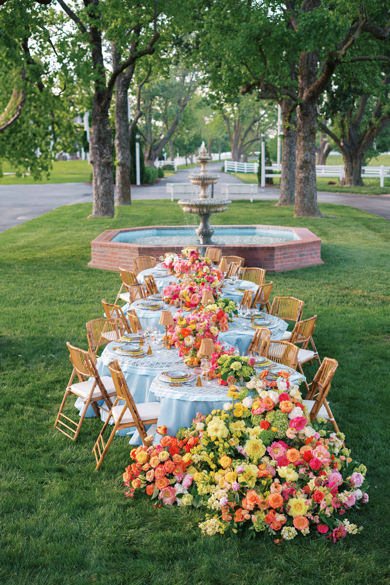 Outdoor colorful serpentine wedding reception tablescape at Lone Summit Ranch
