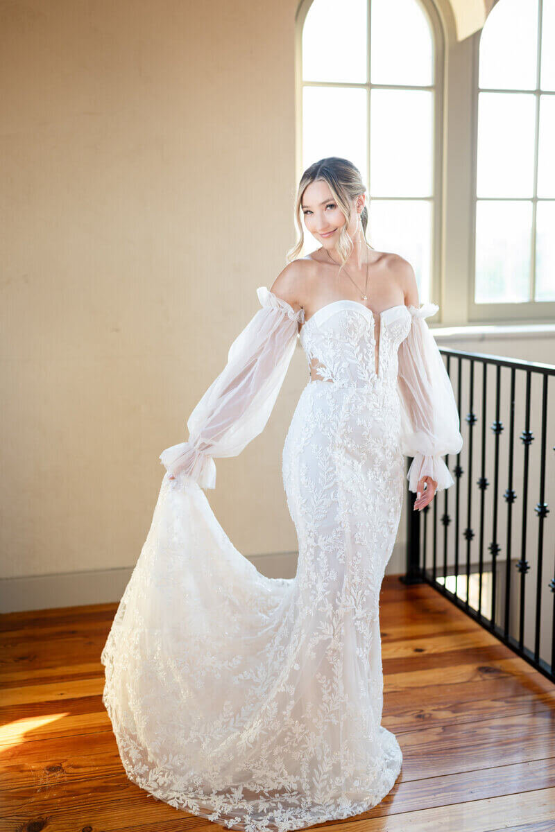 bride holding dress by Atlanta wedding videographers