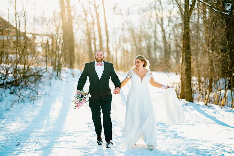 Bride and groom happily walking on a snow