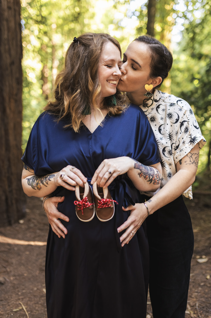 two mom family posing for maternity photos