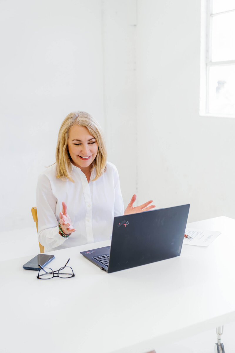 melissa greenwell, headshot, executive leadership coaching on her computer