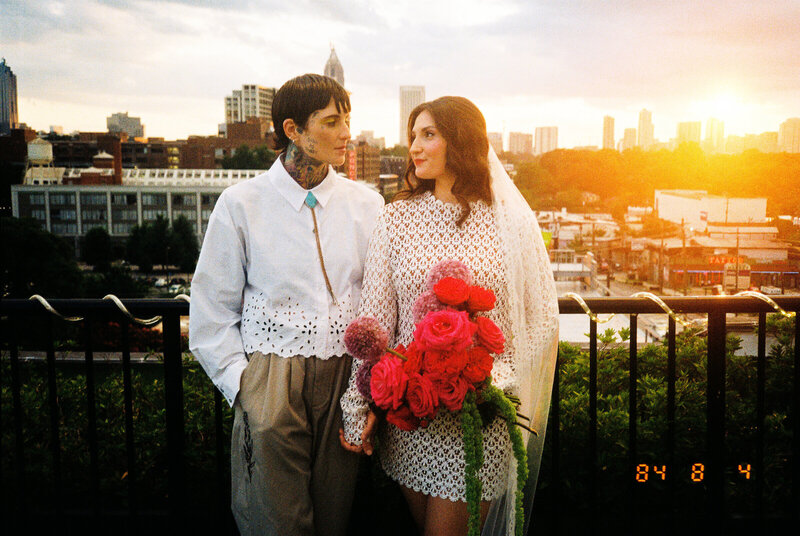 Newlyweds holding wedding flowers in downtown Atlanta.