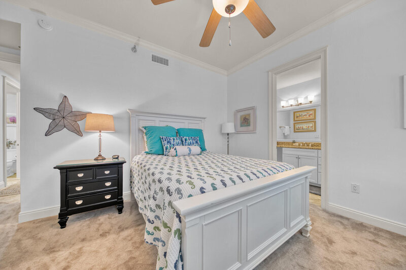 bedroom with queen bed and black night stand