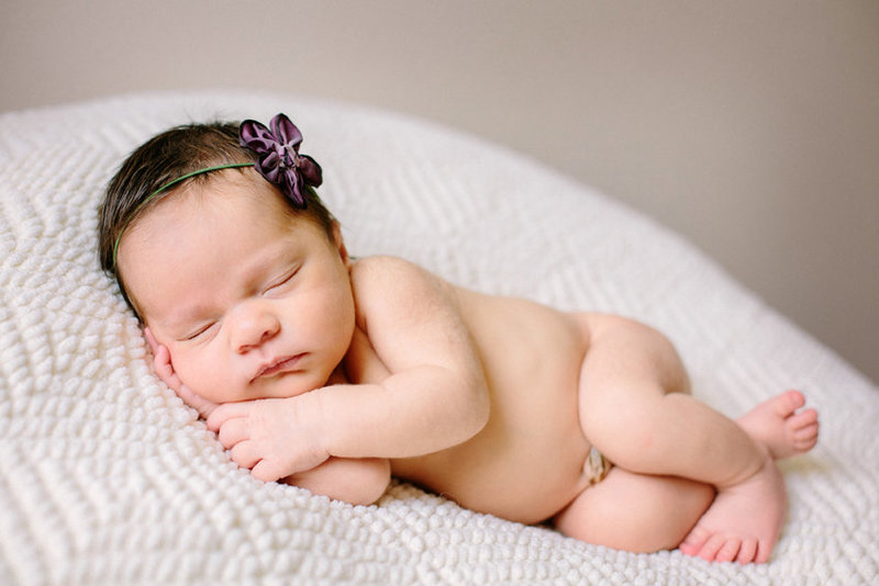 Natural light newborn photograph of a baby sleeping