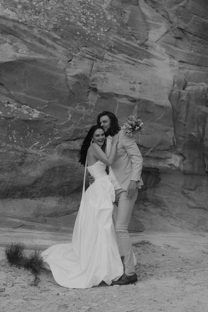 Bride and Groom embracing each other in sandstone canyon