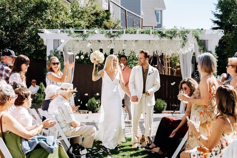 Bride Lounging on Bar With Partner Sitting Below