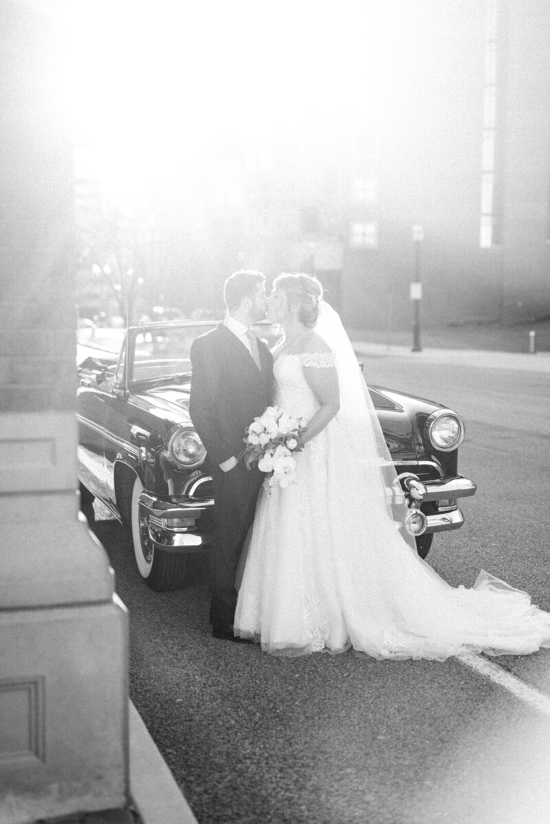 luxury wedding photo of bride and groom in front of vintage car at ritz carlton st louis missouri