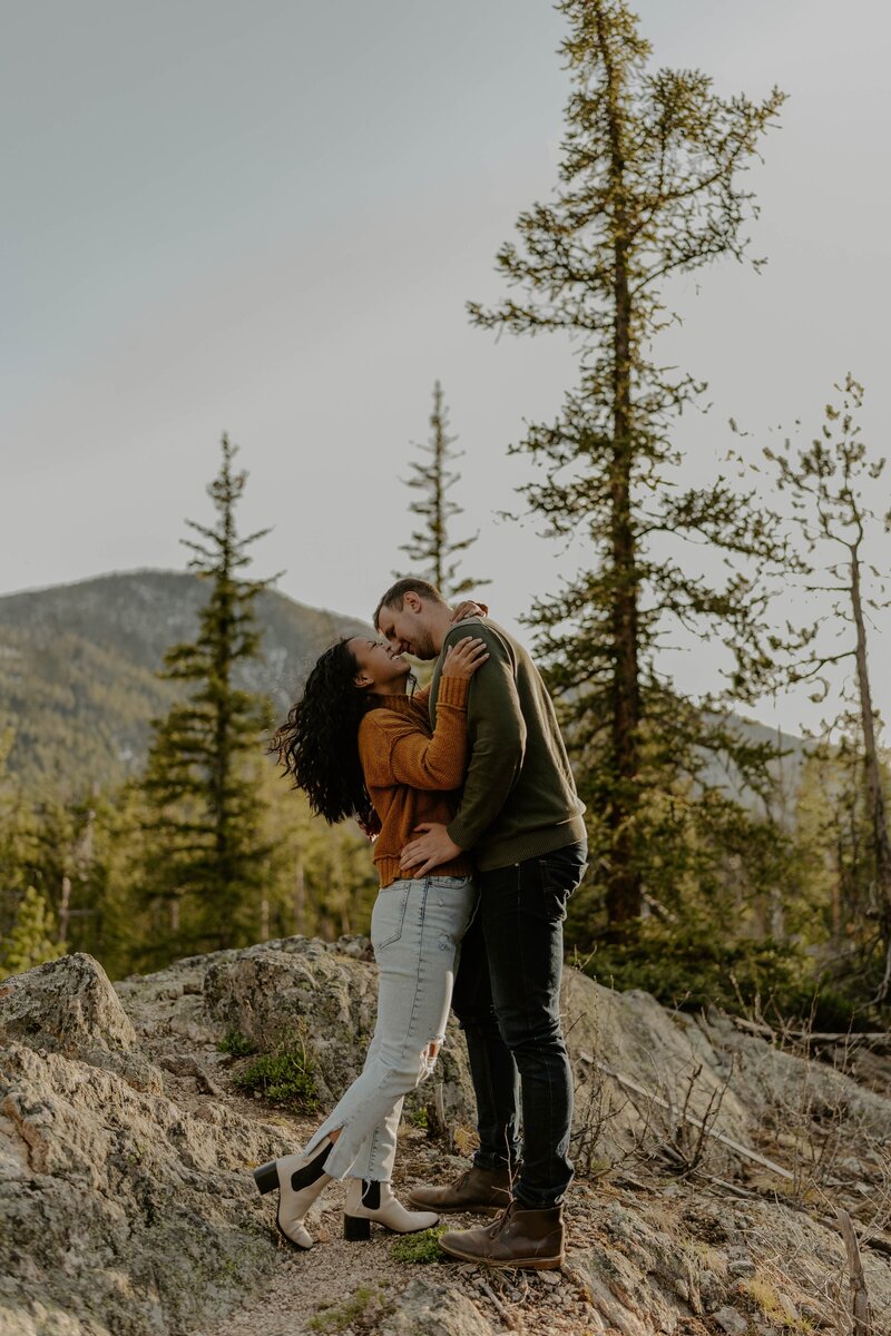 bride and groom kissing in front of veil