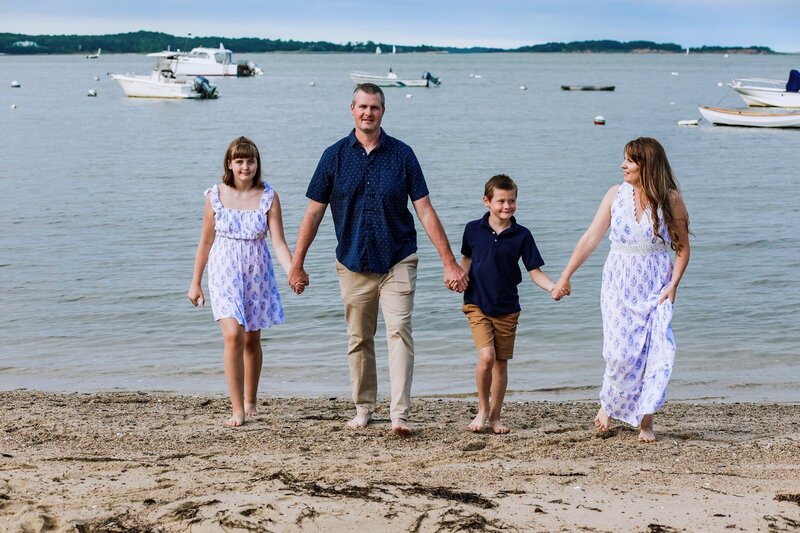 Heidi and her family holding hands walking on Cape Cod Beach | Maine Wedding and Portrait Photographer