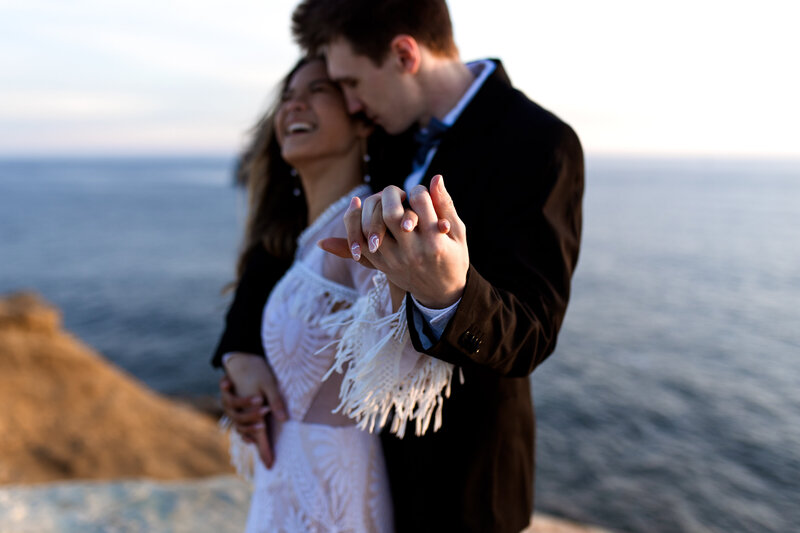 Couple sharing an intimate moment by the Oregon Coast, captured by an Oregon Coast Elopement and Wedding Photographer.