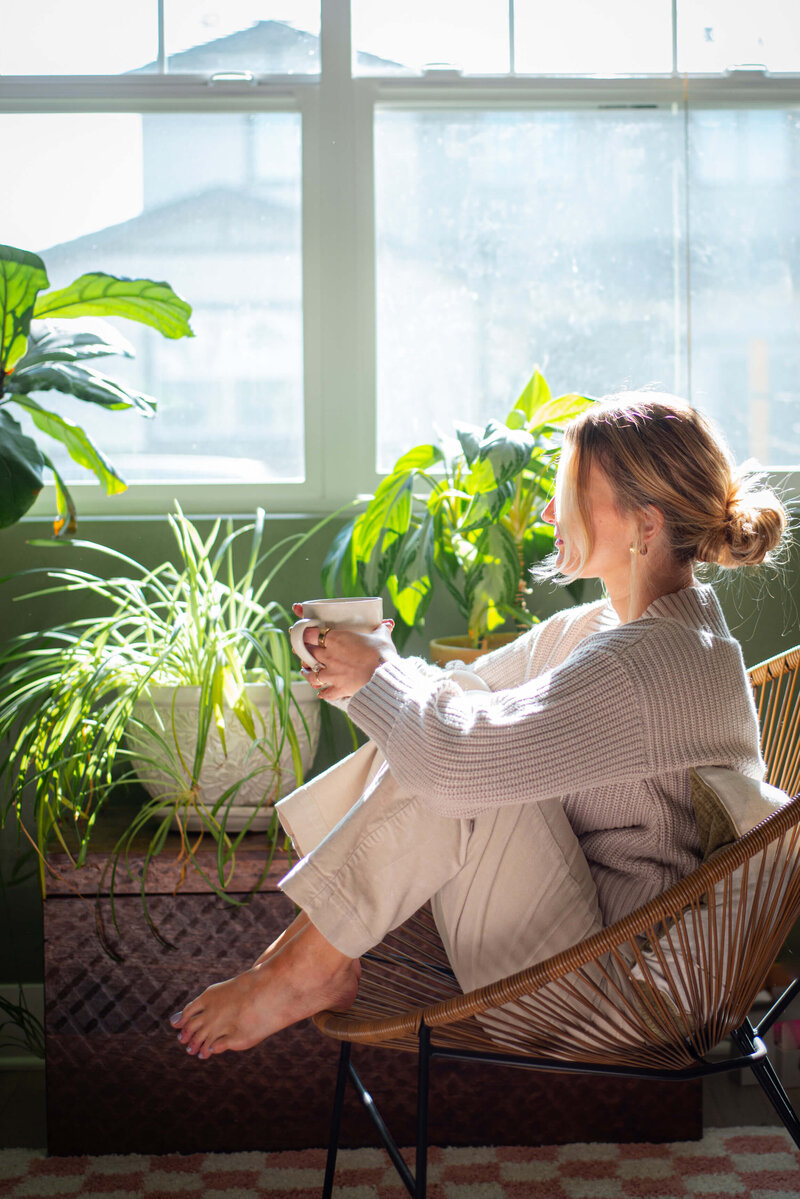 Women sitting next to window drinking coffee