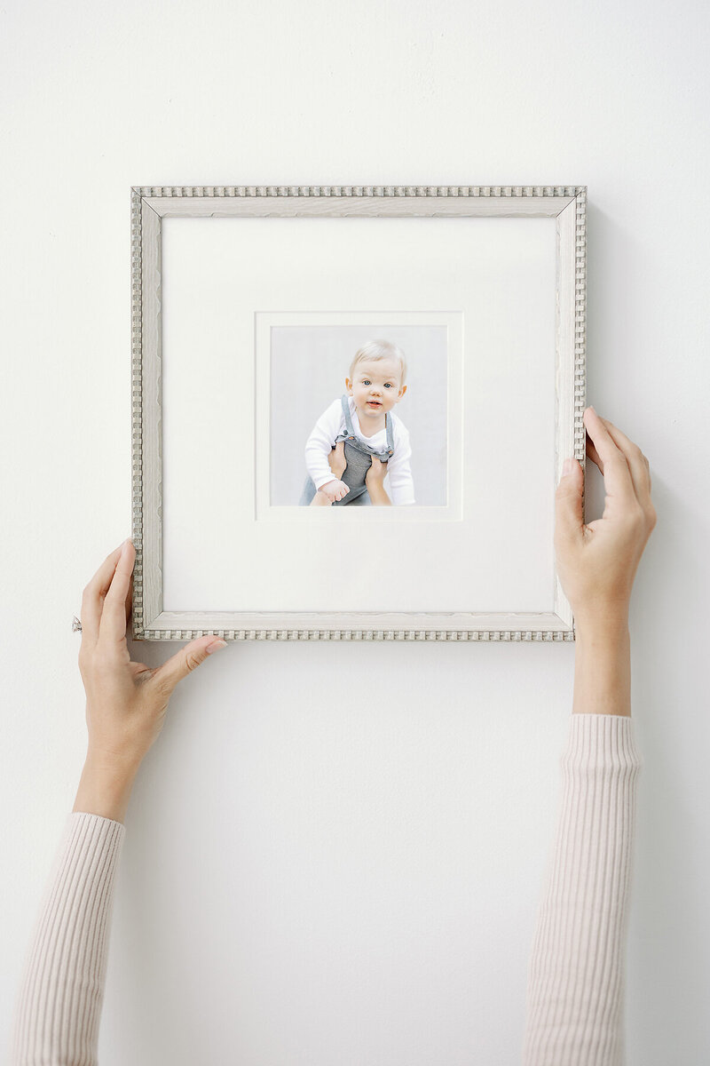 a photo of a child being hung on a wall.