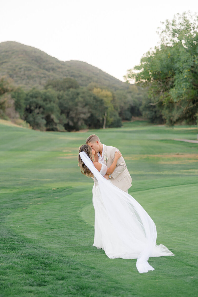 couple kissing in an open field