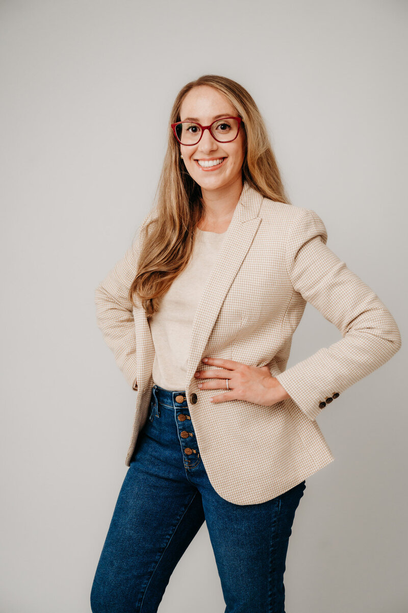 Rachel Toner, food scientist and owner of Taste Strategy, standing and wearing nude blazer and blue jeans