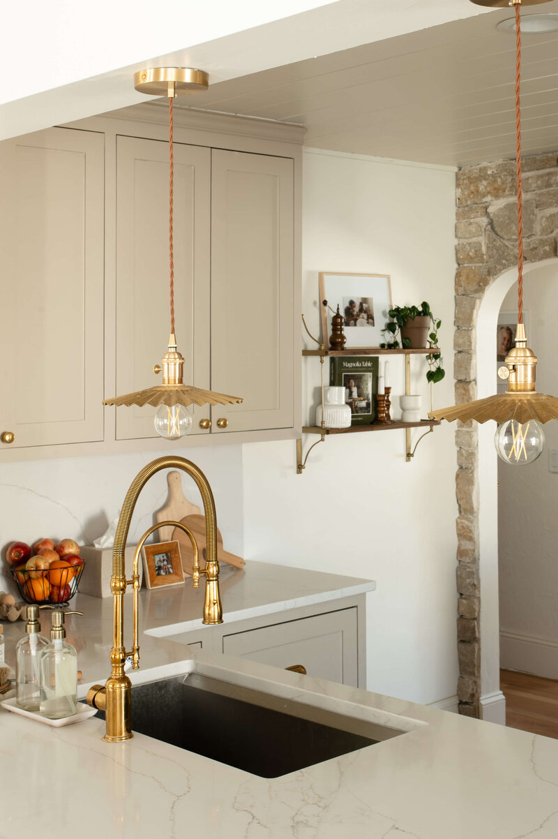 gold sink and light fixtures in kitchen photography