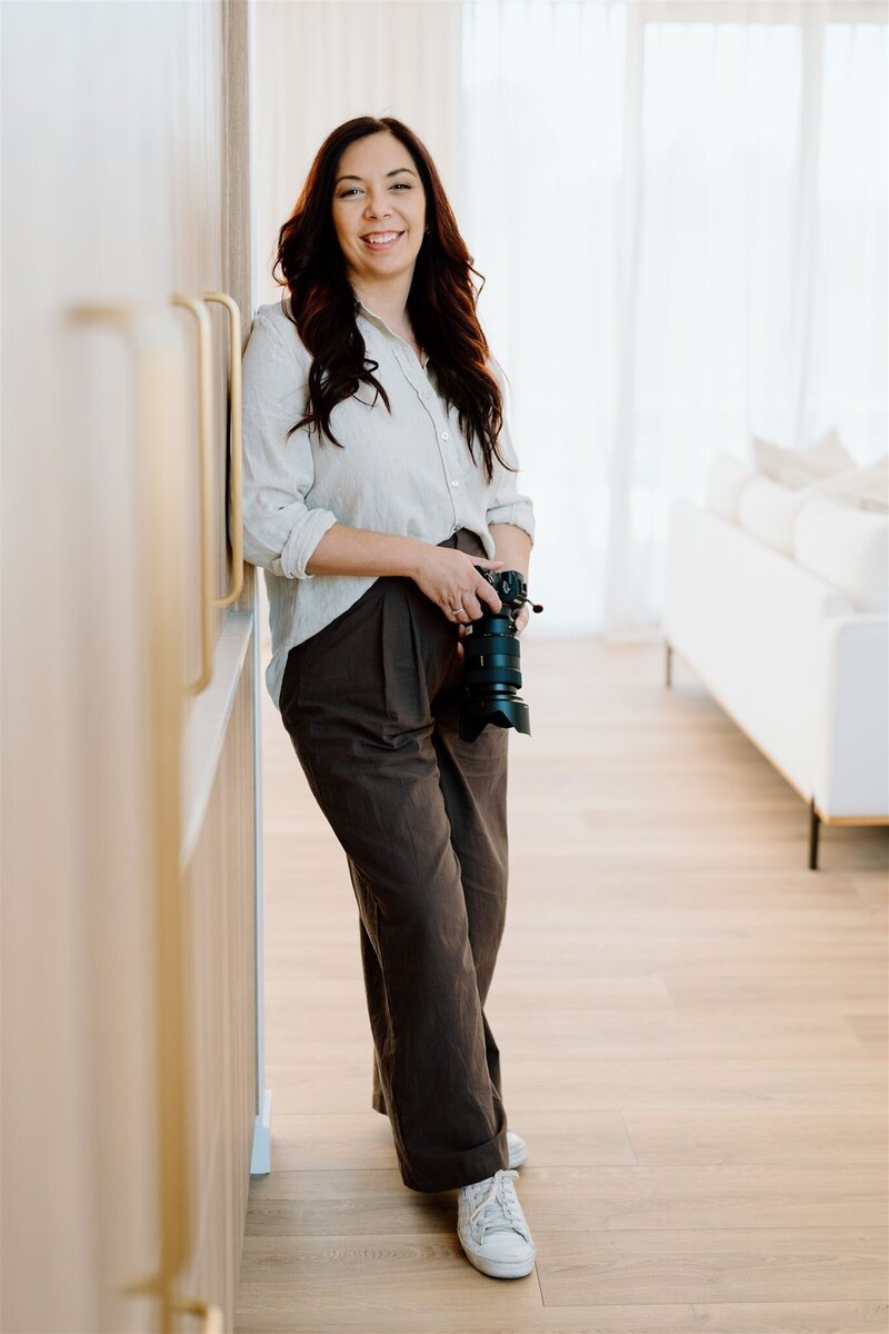 A photo of Tashina Narelle posing with her camera