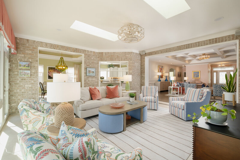 Living room remodel of a vibrant home, featuring bold colors, custom millwork, and unique textures and patterns. The space is designed with custom furnishings, new lighting, and personalized window treatments, reflecting the homeowner's love for travel and world-inspired design.