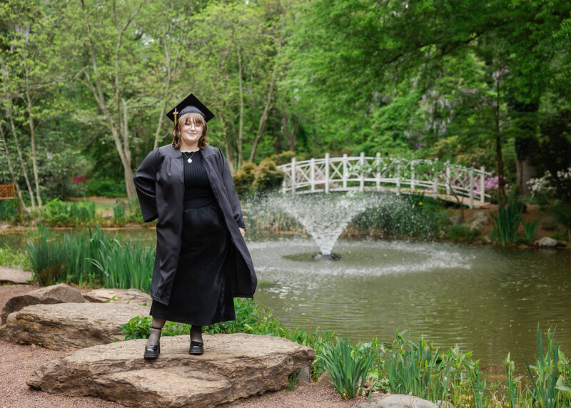 Posed photo of a graduate wearing a graduation cap and gown.
