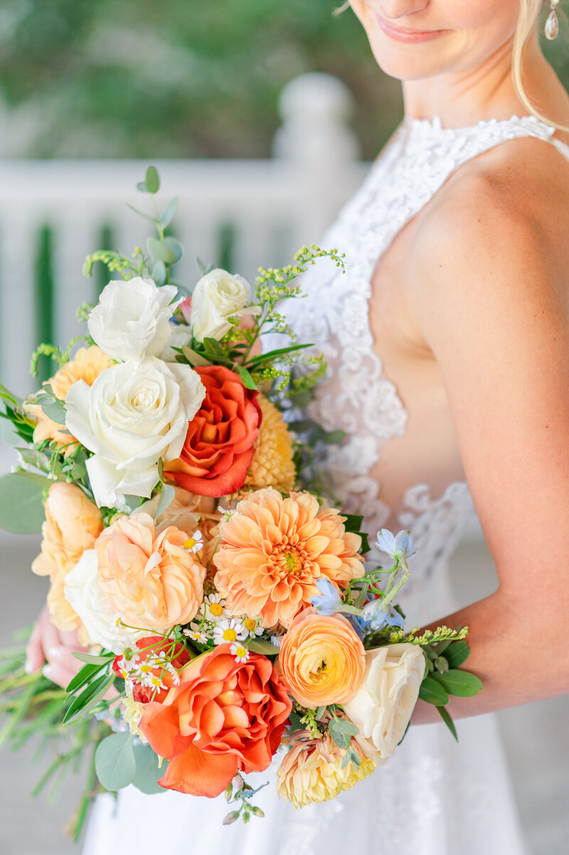 Close up of bride's orange and rust colored bridal bouquet.