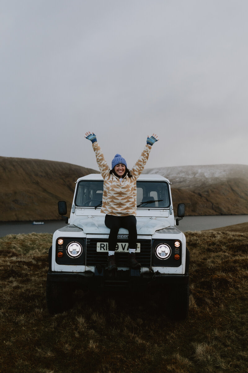 woman sitting on a jeep