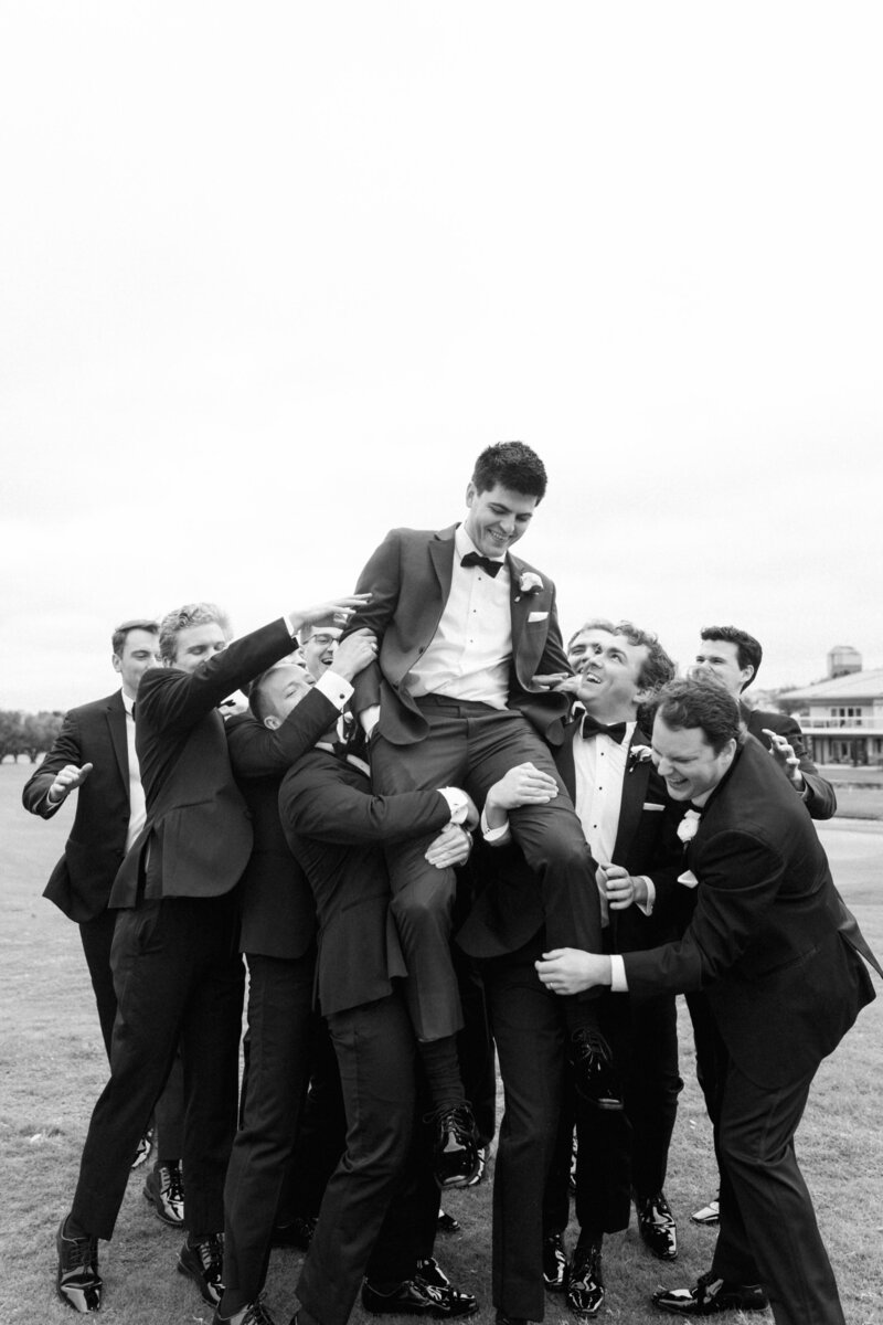 Candid moment with groom and groomsmen at modern Dallas wedding