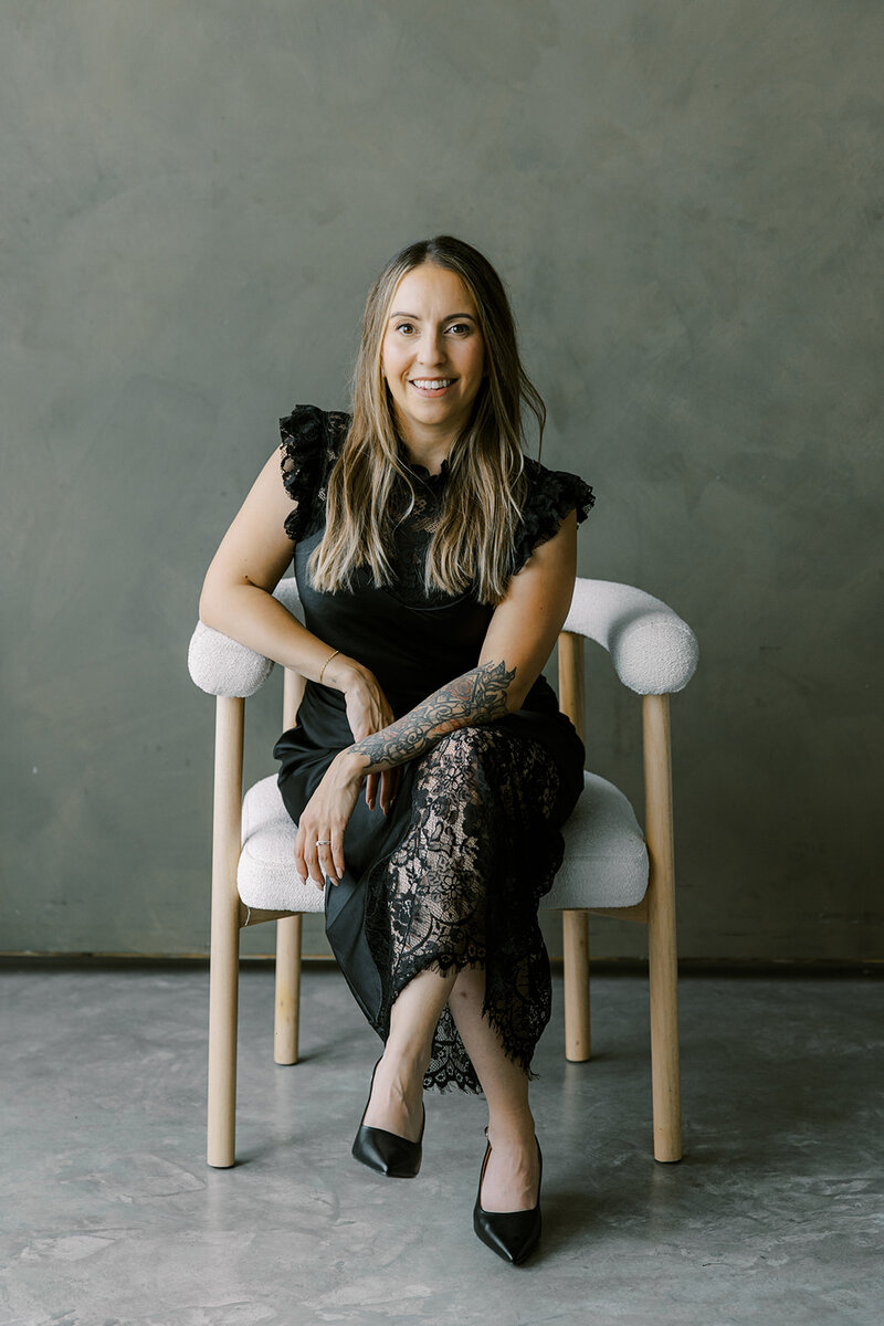 Owner of Melissa Alison Events sitting in a chair with a black outfit for branding photoshoot.