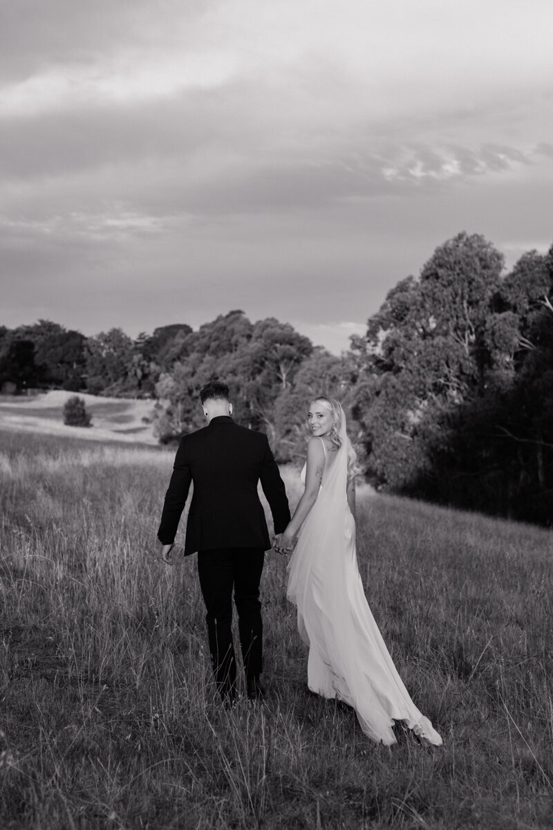 Adelaide hills wedding photography in a grass field featuring bride and groom.