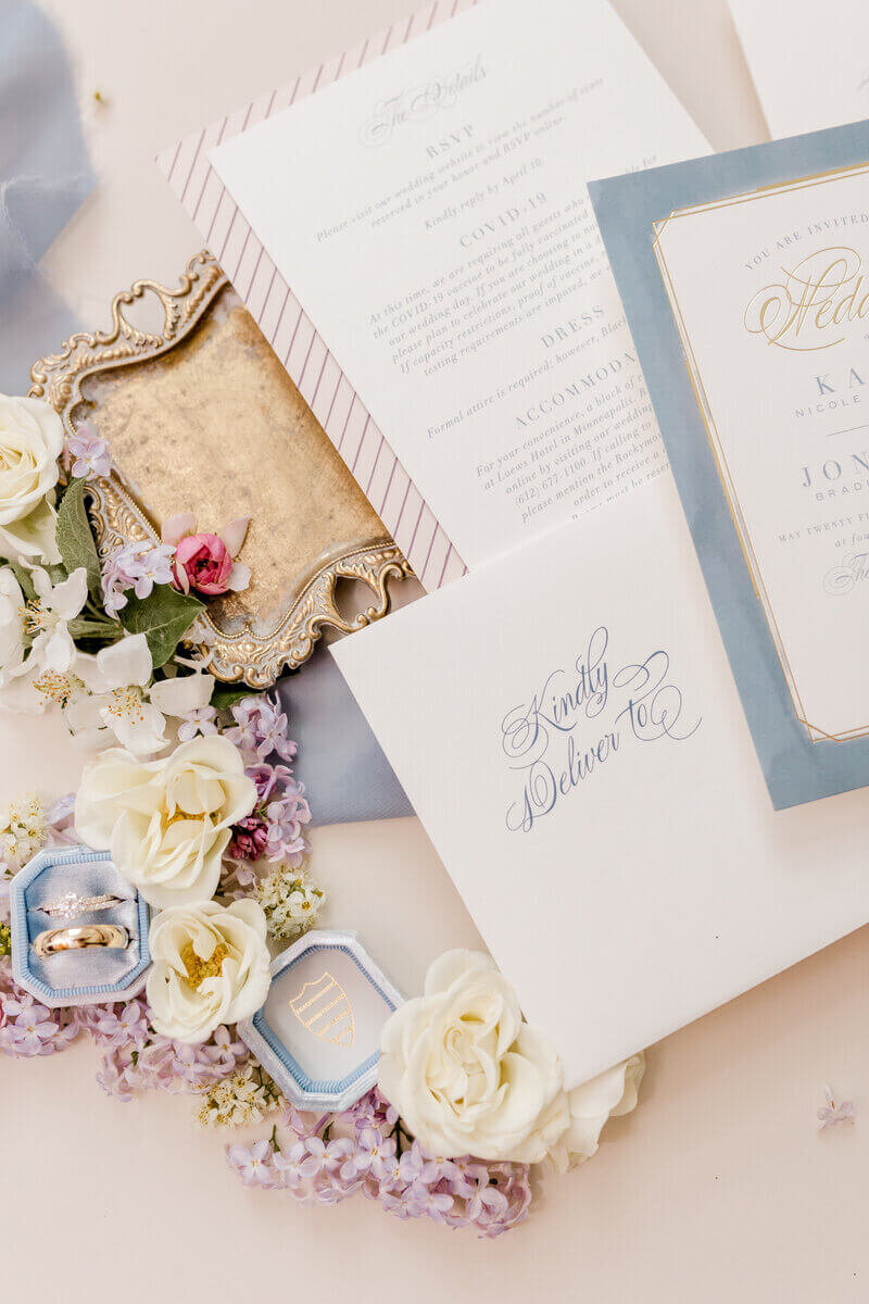 wedding invitation suite and rings styled by wedding planners mn