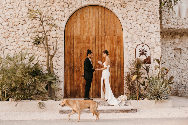couple eloping in mexico sharing vows