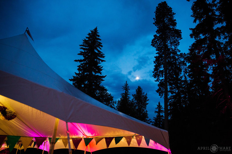 Pretty tent wedding with moon glowing in the distance at Estes Park Condos in Colorado