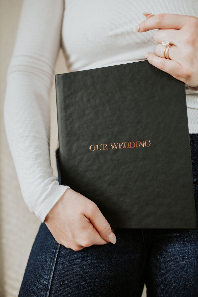 a mirror reflection showing a groom buttoning his suit jacket