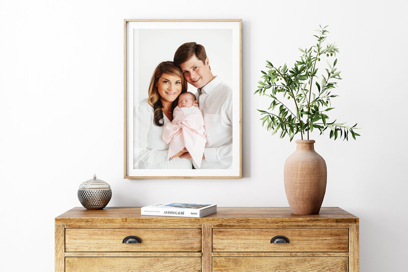 Parents embrace their infant during Newborn Photoshoot in Charleston, SC.