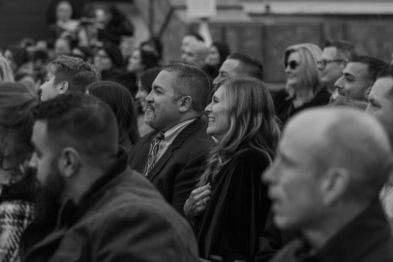 Guests smiling and laughing as they sit at a wedding 