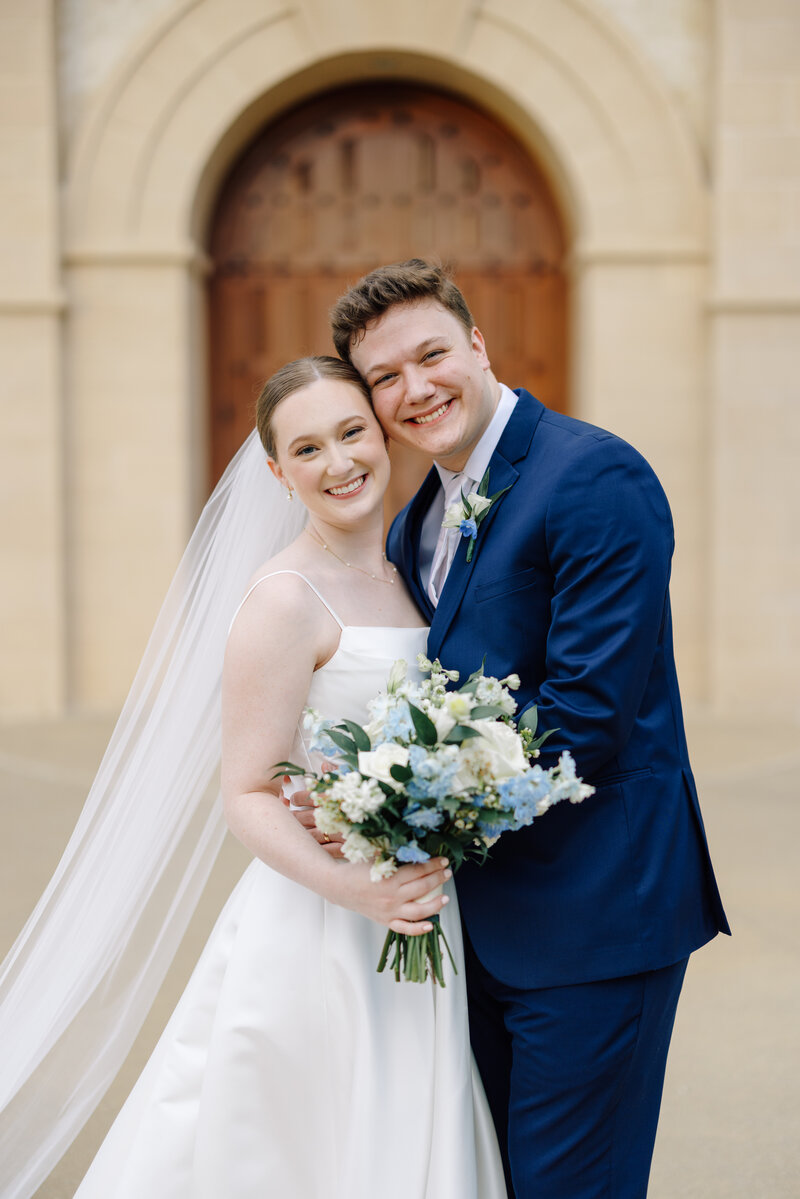 Bride and groom share a kiss after their wedding ceremony at St. Martin De Porres Catholic Church in Lake Charles, captured by Morgan Alysse, Lafayette wedding photographer.