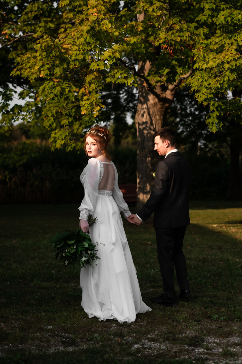 Bride groom walking in bright sunlight