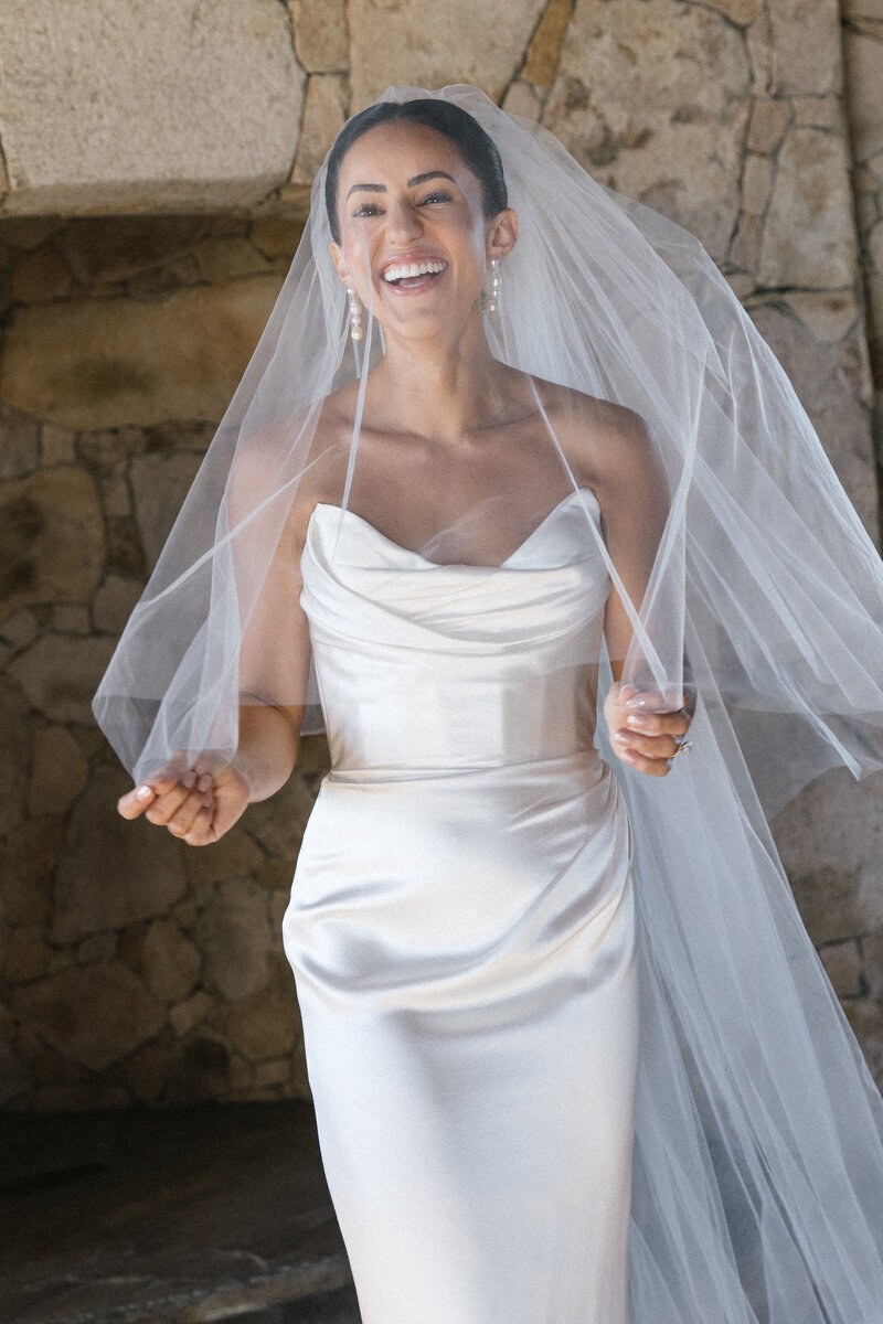 bride under veil laughing 