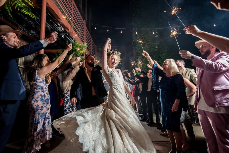 a bride spins at her wedding dress at a sparkler exit for her wedding in Austin, TX