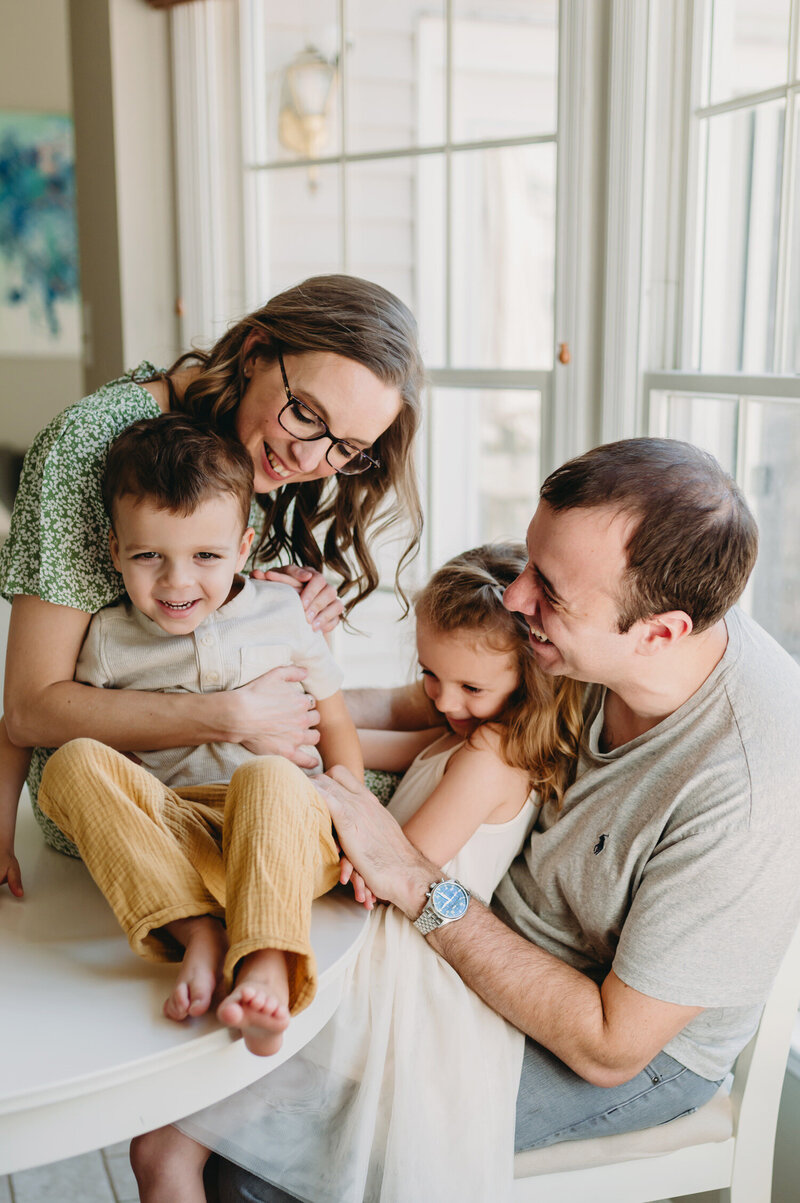 family of four laughing