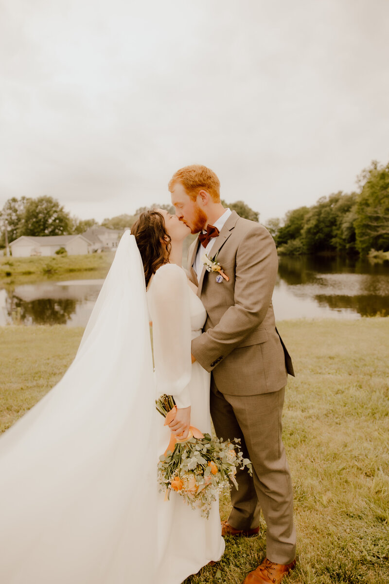 couple kissing during outdoor wedding photos in missouri