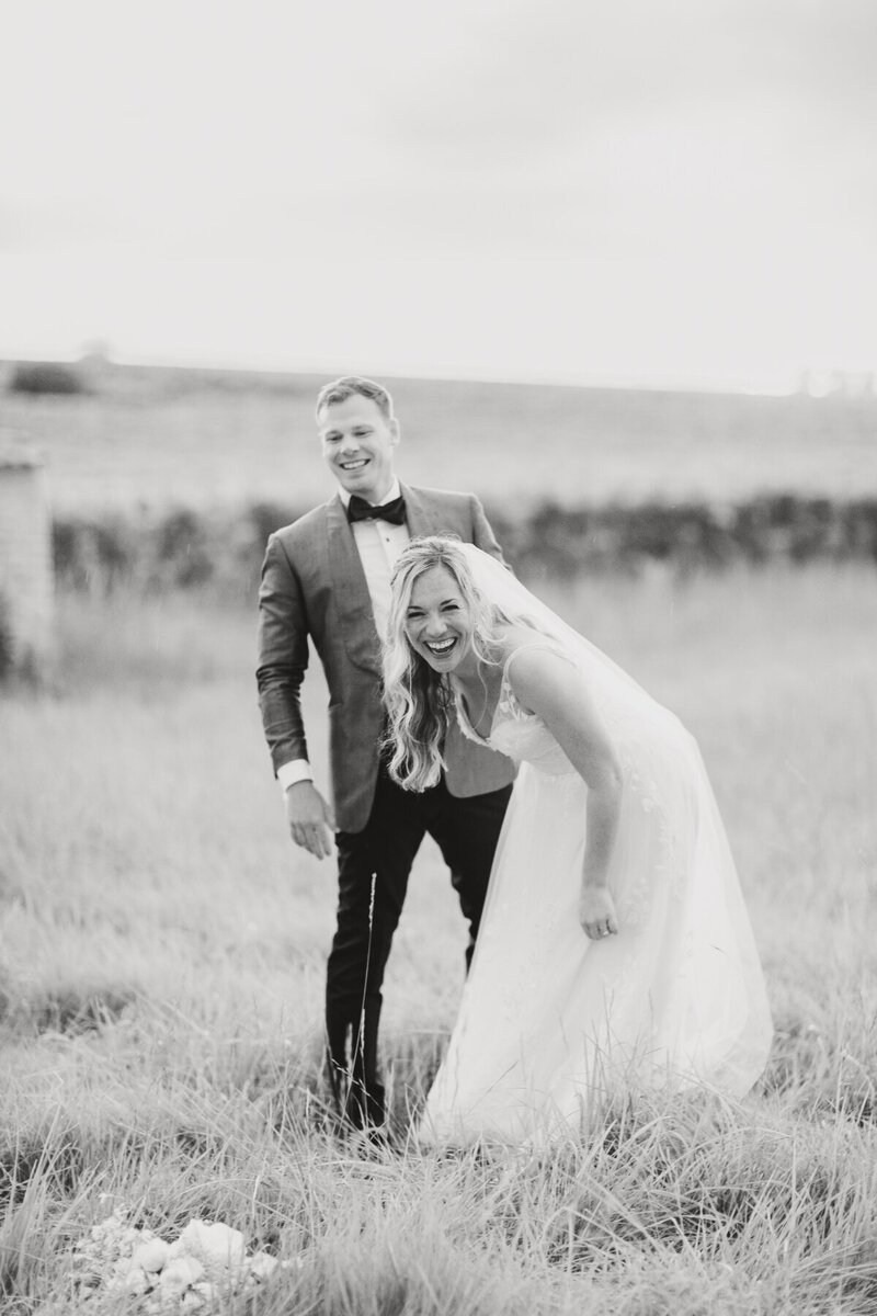 bride-groom-laughing-field